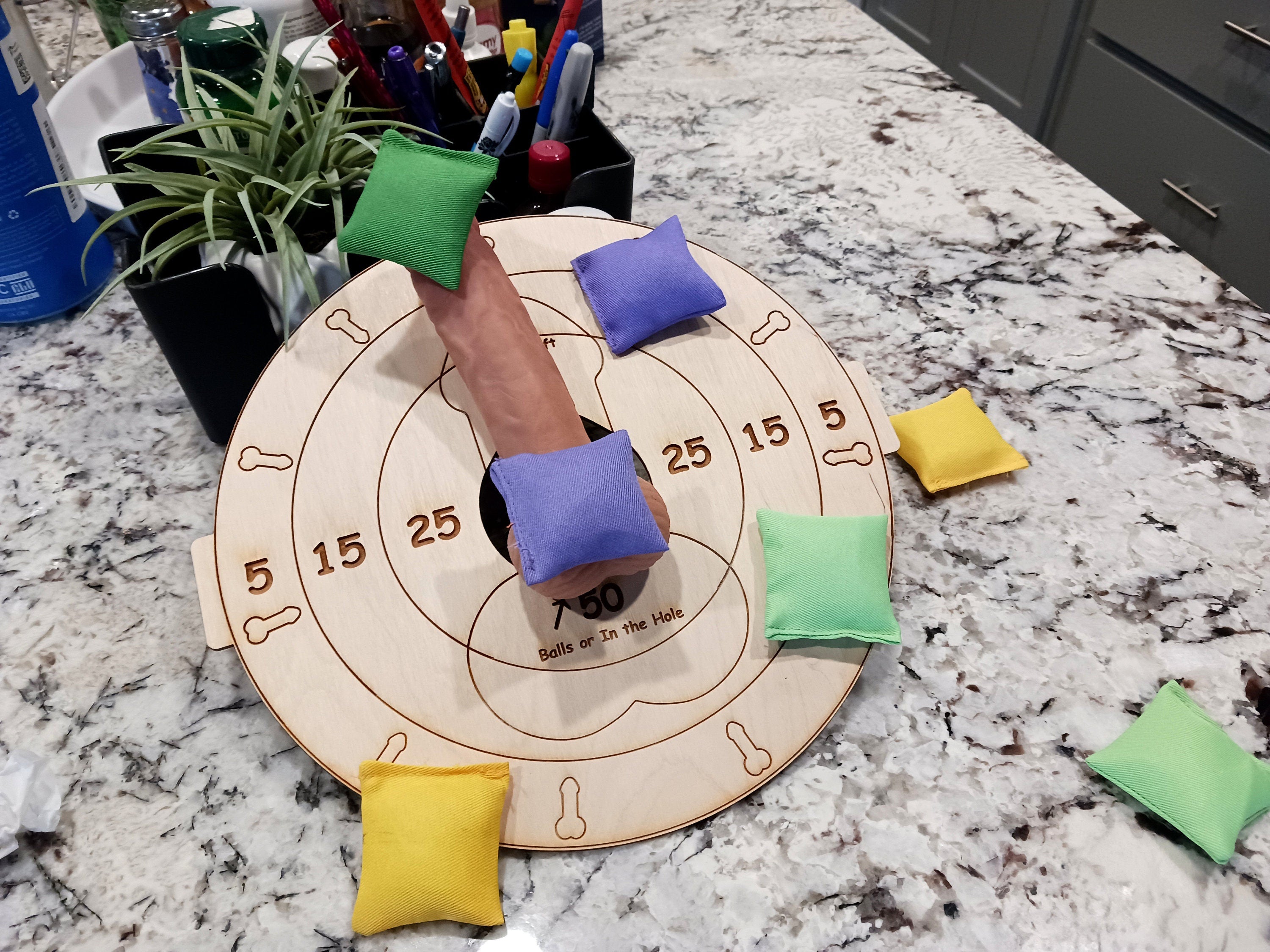 Sexy humiliation game. It can be worn on the lap, or setup as a table top cornhole game. Use your imagination! Lightweight board only, no stand included, bean bags optional could be worn by submissive man laying down with penis balls inside the hole.  Welcome to The Mistress Dominatrix Challenge, the ultimate kinky board game with female domination as its theme! As a player, SHE takes on the role of The Mistress in order to dominate and control your willing partners.