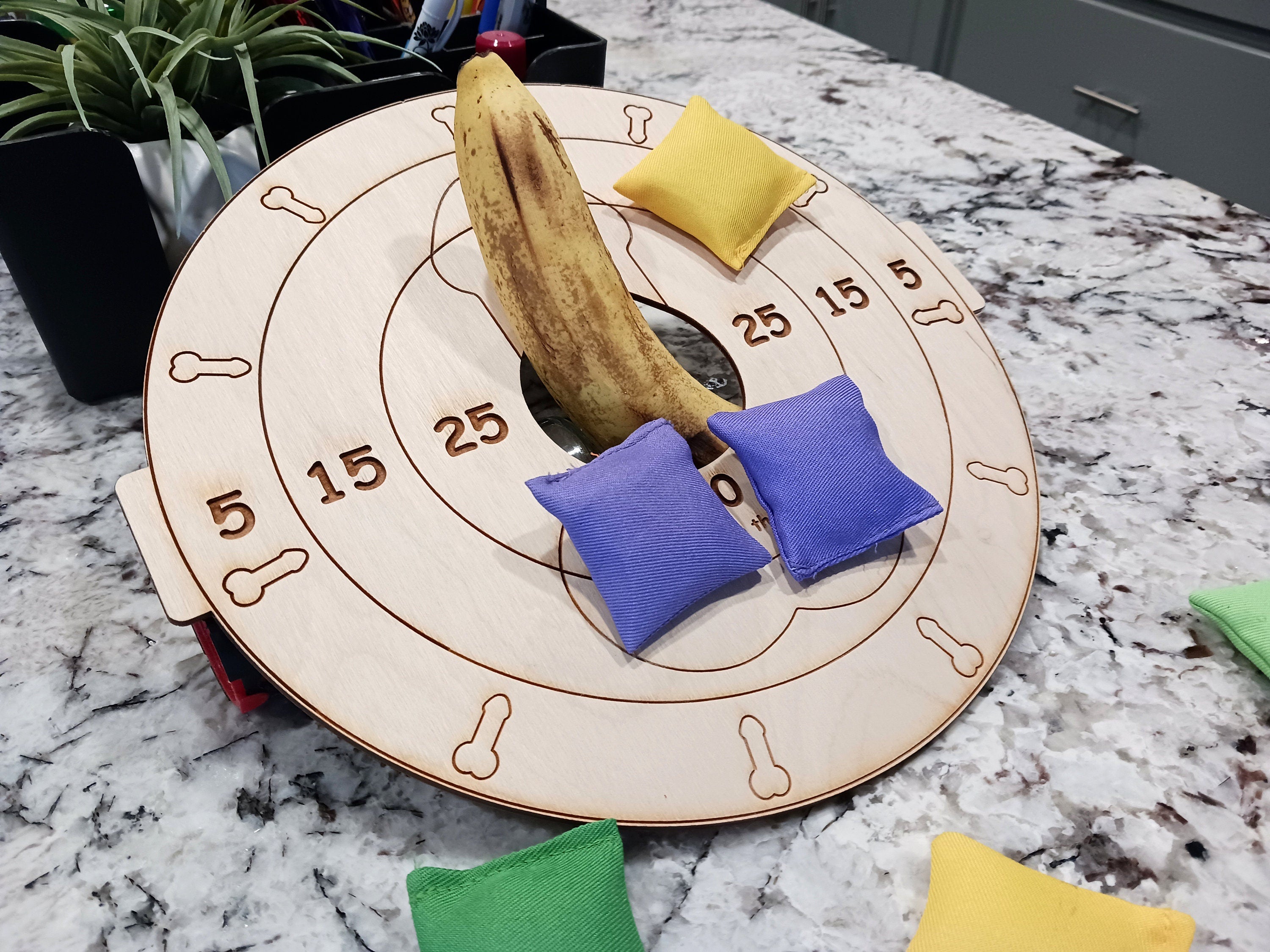 Sexy humiliation game. It can be worn on the lap, or setup as a table top cornhole game. Use your imagination! Lightweight board only, no stand included, bean bags optional could be worn by submissive man laying down with penis balls inside the hole.  Welcome to The Mistress Dominatrix Challenge, the ultimate kinky board game with female domination as its theme! 
