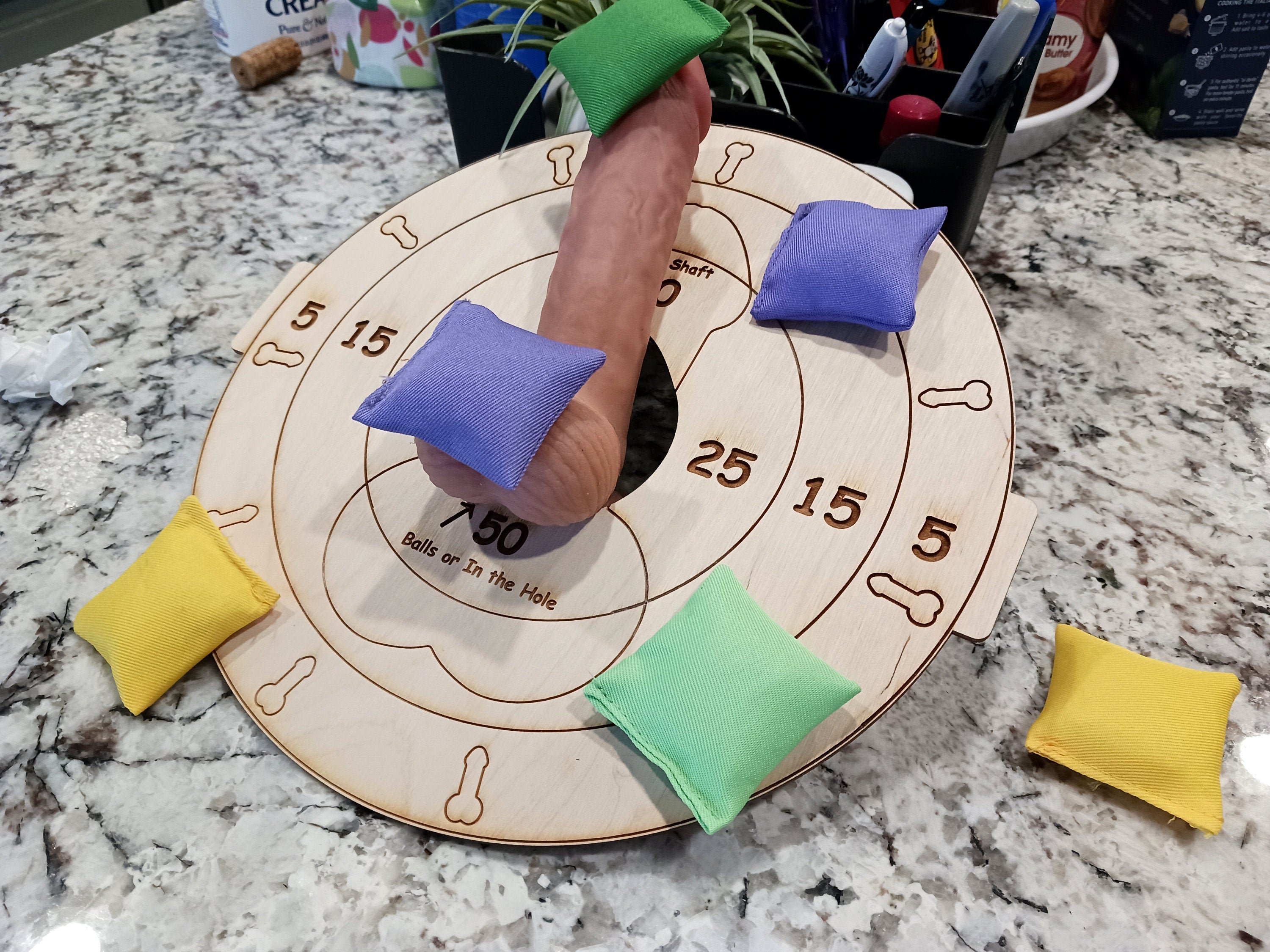 Sexy humiliation game. It can be worn on the lap, or setup as a table top cornhole game. Use your imagination! Lightweight board only, no stand included, bean bags optional could be worn by submissive man laying down with penis balls inside the hole.  Welcome to The Mistress Dominatrix Challenge, the ultimate kinky board game with female domination as its theme! As a player, SHE takes on the role of The Mistress in order to dominate and control your willing partners.